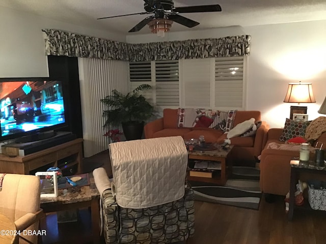 living room featuring hardwood / wood-style floors and ceiling fan