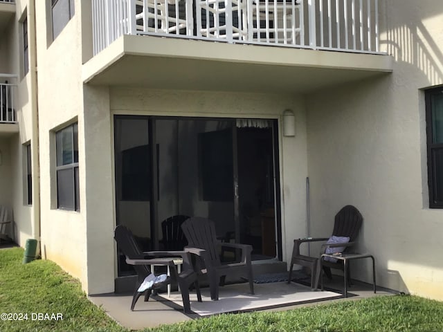 back of house with a patio and a balcony