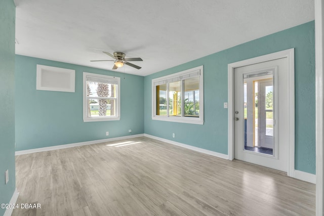 spare room featuring light wood-type flooring and ceiling fan