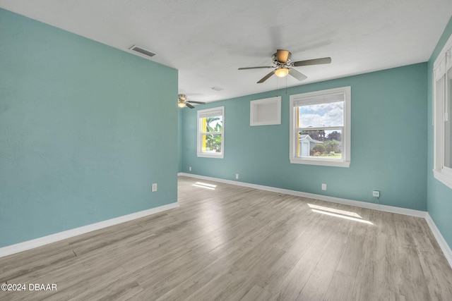 spare room featuring ceiling fan and light hardwood / wood-style flooring