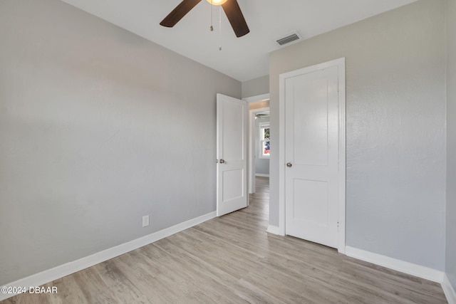 unfurnished bedroom with ceiling fan and light hardwood / wood-style flooring