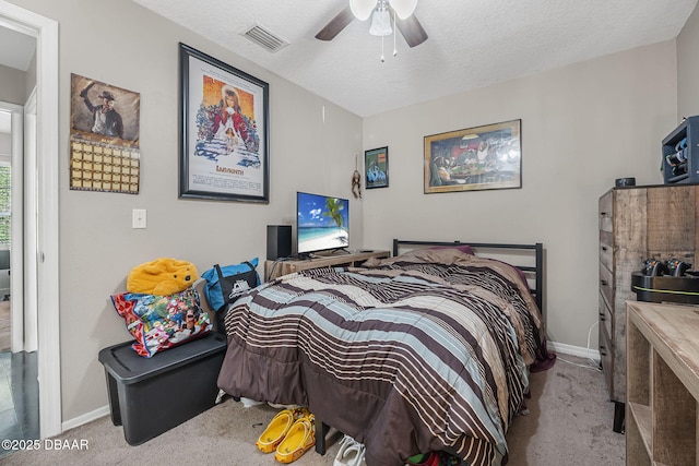 bedroom featuring carpet flooring, baseboards, ceiling fan, and a textured ceiling