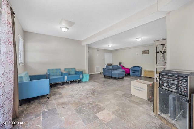 sitting room featuring stone finish flooring