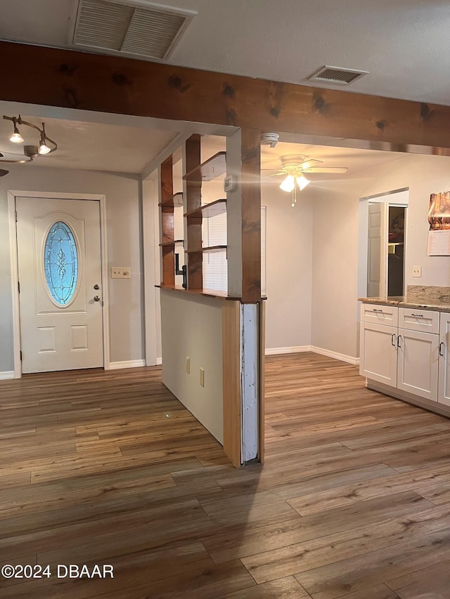 foyer entrance with hardwood / wood-style floors and ceiling fan