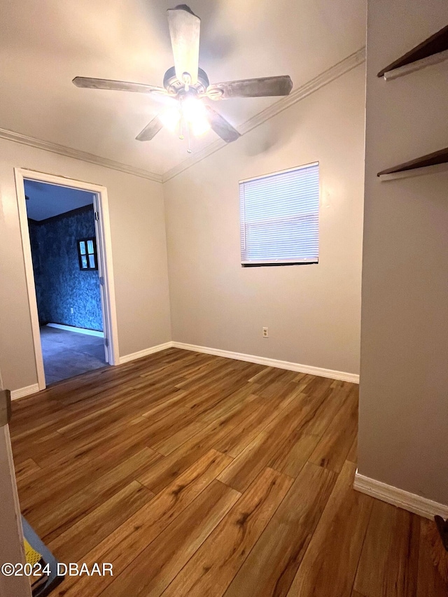 spare room with ornamental molding, dark hardwood / wood-style floors, and ceiling fan