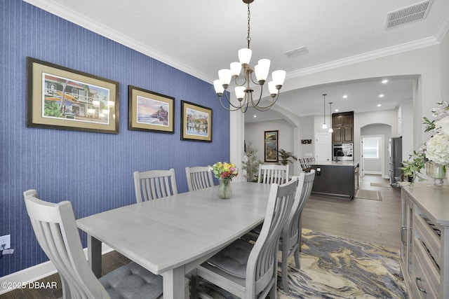 dining space featuring visible vents, wallpapered walls, crown molding, dark wood finished floors, and arched walkways