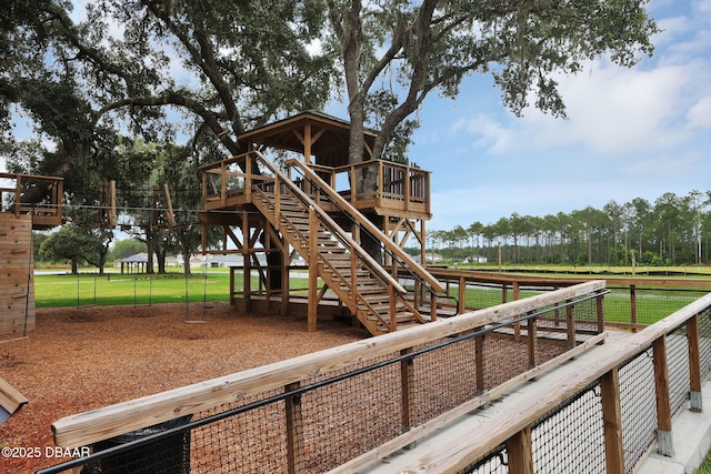 view of playground featuring stairs and a wooden deck