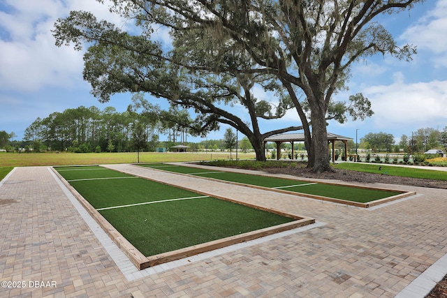 view of property's community with a gazebo and a lawn