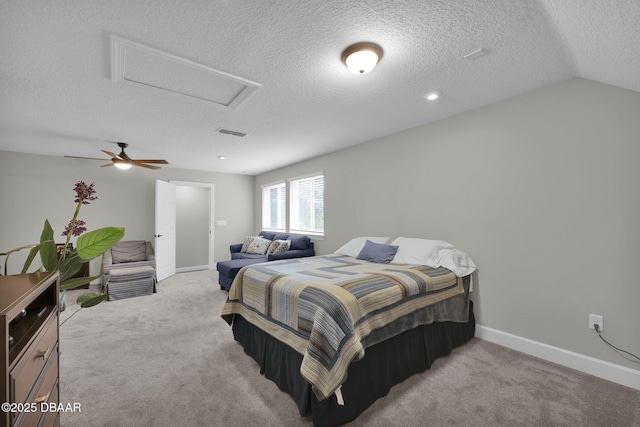 carpeted bedroom featuring baseboards, visible vents, attic access, lofted ceiling, and a textured ceiling