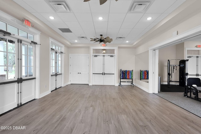 interior space with light wood finished floors, visible vents, and ceiling fan