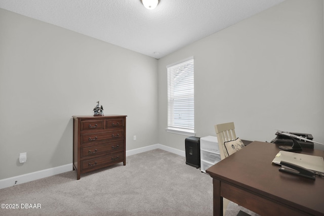 home office featuring baseboards, light colored carpet, and a textured ceiling