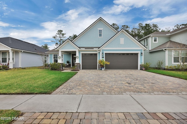 craftsman-style home with a front yard and decorative driveway