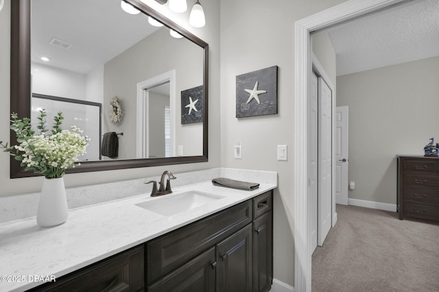 bathroom with visible vents, baseboards, and vanity