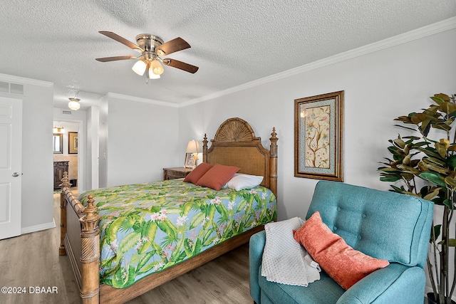 3370 Ocean Shore Blvd Unit 404B, Ormond Beach, FL 32176 - bedroom with wood finished floors, a textured ceiling, ornamental molding, ceiling fan, and connected bathroom