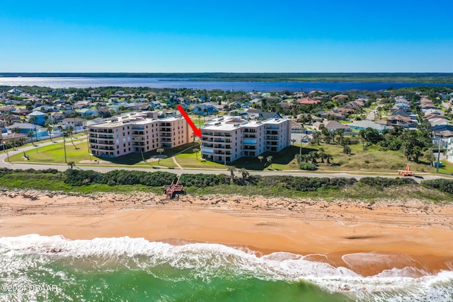 drone / aerial view with a beach view and a water view