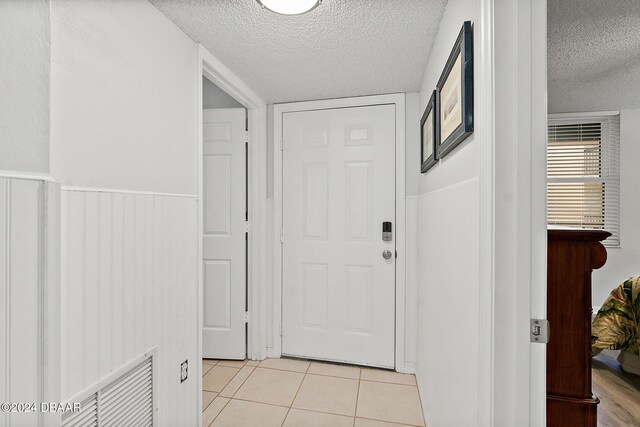 3370 Ocean Shore Blvd Unit 404B, Ormond Beach, FL 32176 - entryway featuring a textured ceiling and light tile patterned floors