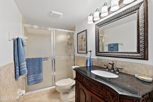 3370 Ocean Shore Blvd Unit 404B, Ormond Beach, FL 32176 - full bathroom with tile walls, vanity, a stall shower, tile patterned flooring, and toilet