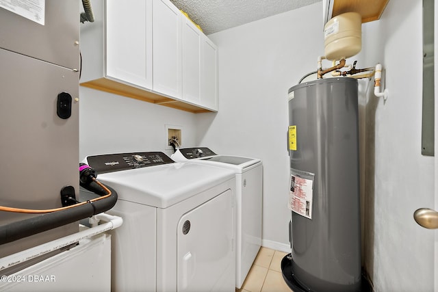 3370 Ocean Shore Blvd Unit 404B, Ormond Beach, FL 32176 - laundry room with water heater, separate washer and dryer, cabinet space, light tile patterned floors, and a textured ceiling