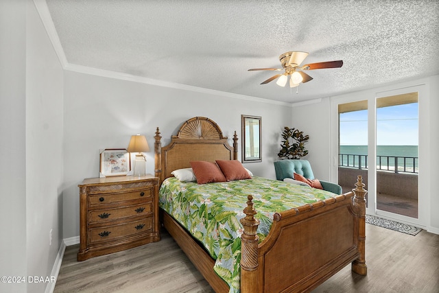 3370 Ocean Shore Blvd Unit 404B, Ormond Beach, FL 32176 - bedroom with access to outside, light wood-type flooring, baseboards, ceiling fan, and a textured ceiling