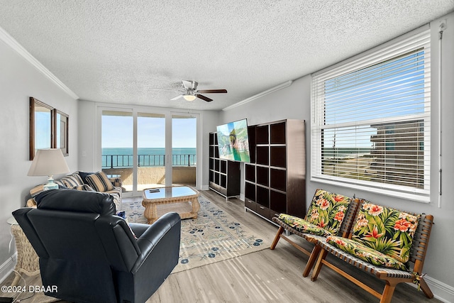 3370 Ocean Shore Blvd Unit 404B, Ormond Beach, FL 32176 - living room with wood finished floors, plenty of natural light, ceiling fan, ornamental molding, and a textured ceiling