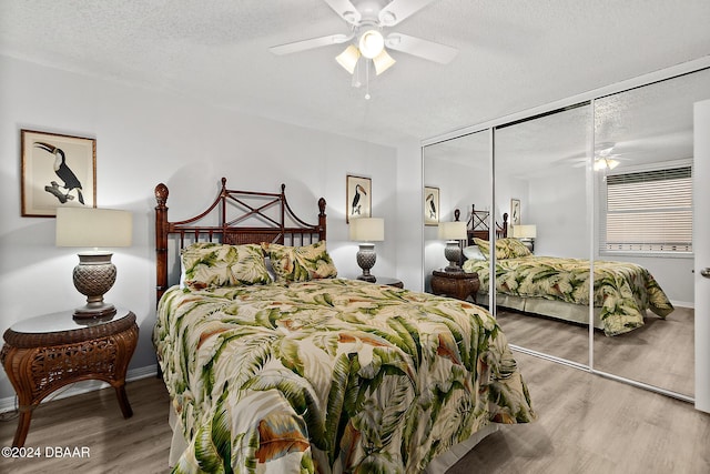 3370 Ocean Shore Blvd Unit 404B, Ormond Beach, FL 32176 - bedroom featuring wood finished floors, a closet, a textured ceiling, ceiling fan, and baseboards