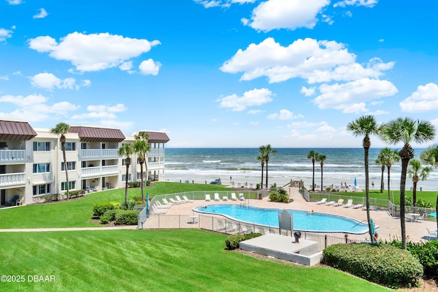 view of pool featuring a water view, a yard, and a patio