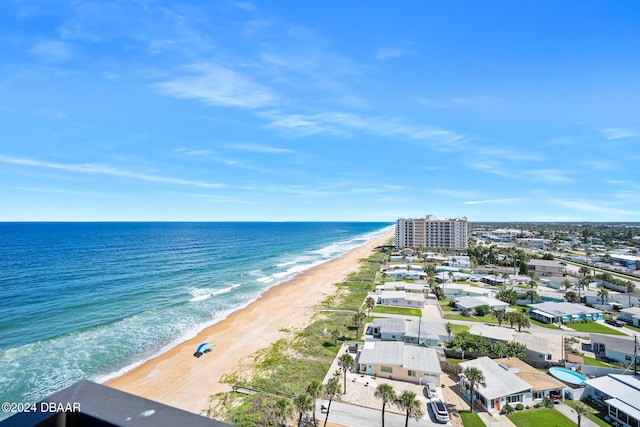 drone / aerial view featuring a view of the beach and a water view