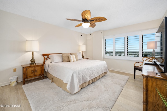 bedroom with ceiling fan and light wood-type flooring