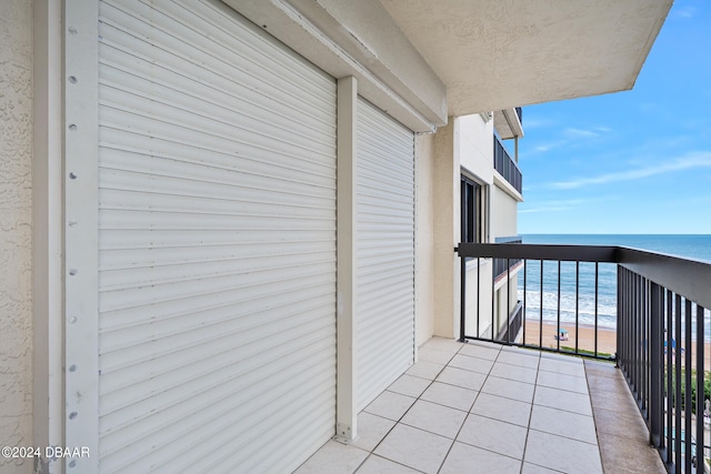 balcony with a water view and a beach view