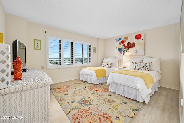 bedroom with light hardwood / wood-style floors