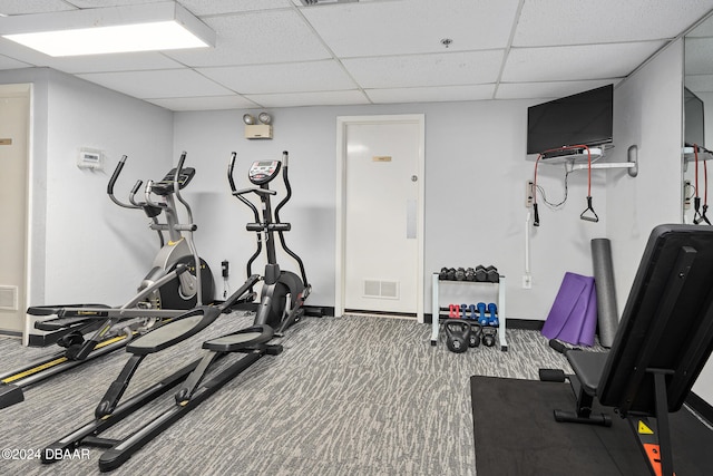 exercise room featuring a drop ceiling and carpet flooring