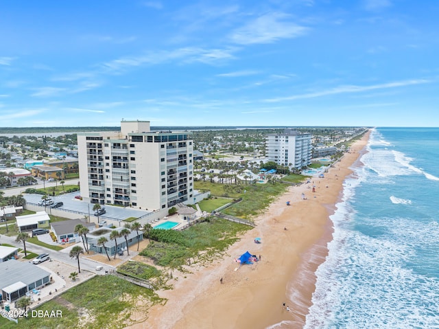 birds eye view of property with a view of the beach and a water view