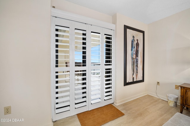 entrance foyer featuring a textured ceiling and light hardwood / wood-style flooring