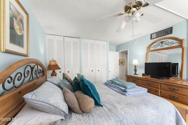 2987 S Atlantic Ave Unit 303, Daytona Beach, FL 32118 - bedroom with a textured ceiling, multiple closets, and ceiling fan