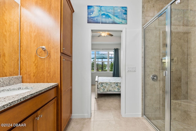 bathroom with tile patterned flooring, vanity, and a shower with shower door