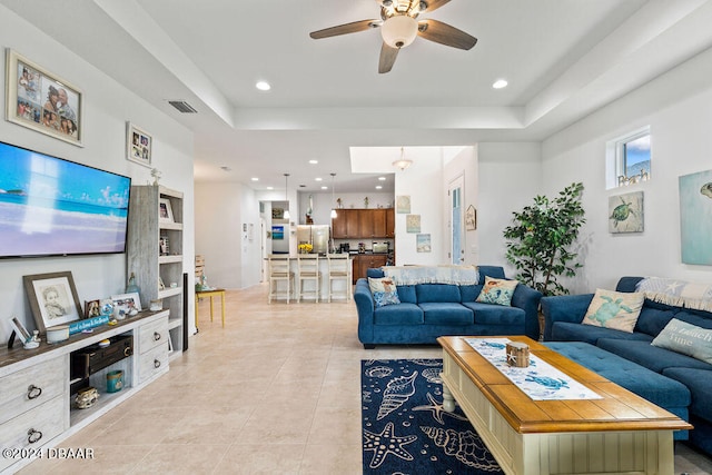 tiled living room with ceiling fan