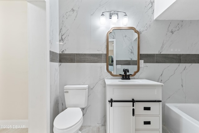 bathroom with vanity, toilet, and a tub