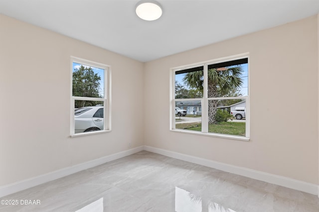 empty room featuring baseboards