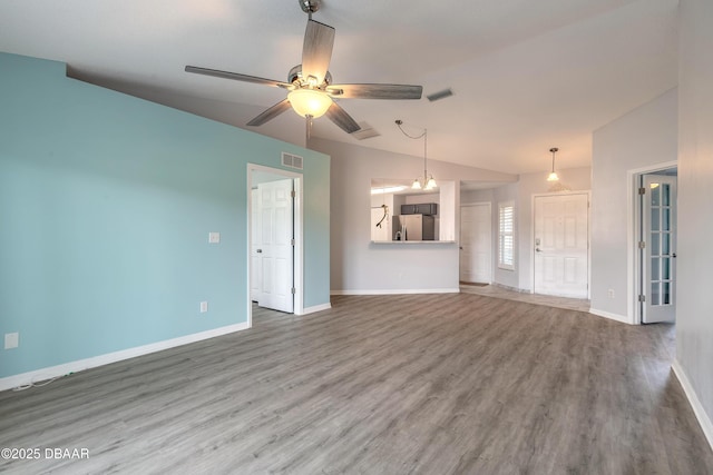 unfurnished living room with wood finished floors, visible vents, and baseboards