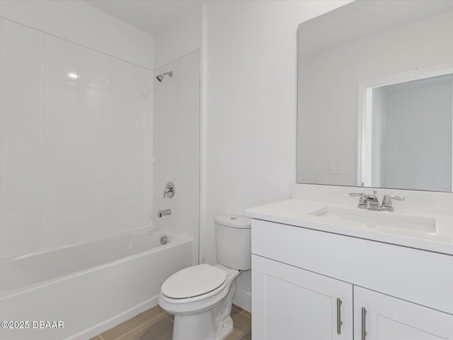 full bathroom featuring vanity, hardwood / wood-style flooring, toilet, and tiled shower / bath