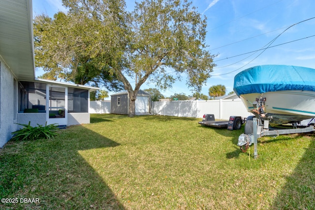 view of yard with a sunroom and a storage unit