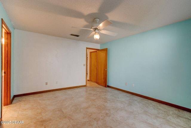 spare room featuring a textured ceiling and ceiling fan