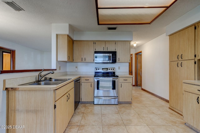 kitchen featuring light brown cabinetry, sink, light tile patterned floors, and appliances with stainless steel finishes