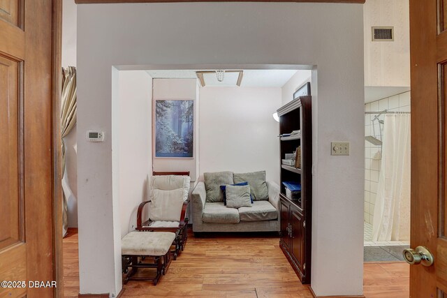 sitting room with light wood-style floors and visible vents