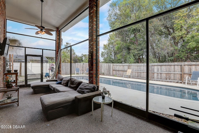 unfurnished sunroom featuring ceiling fan