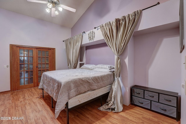 bedroom with lofted ceiling, wood finished floors, and a ceiling fan