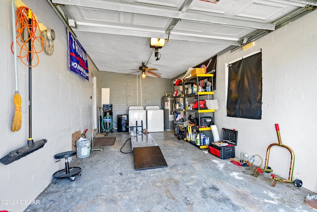 garage with electric water heater, a garage door opener, separate washer and dryer, and ceiling fan