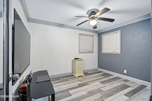 unfurnished office featuring light wood-type flooring, ceiling fan, and crown molding