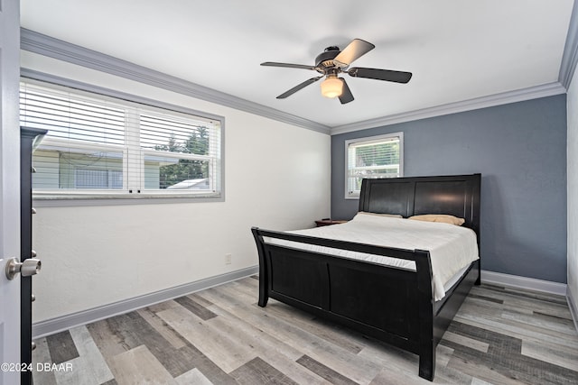 bedroom featuring ceiling fan, ornamental molding, and wood-type flooring