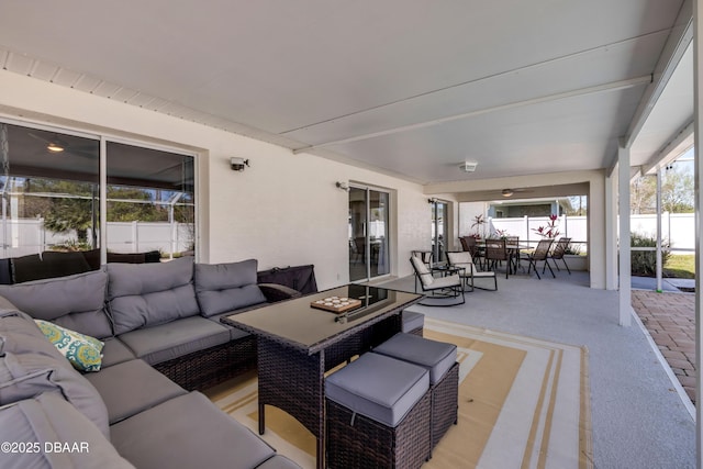 view of patio featuring an outdoor living space, outdoor dining space, and fence